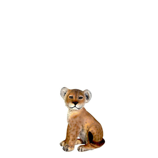 Life-size lion cub sitting statue brings safari magic to kids party rental in Atlanta, GA.